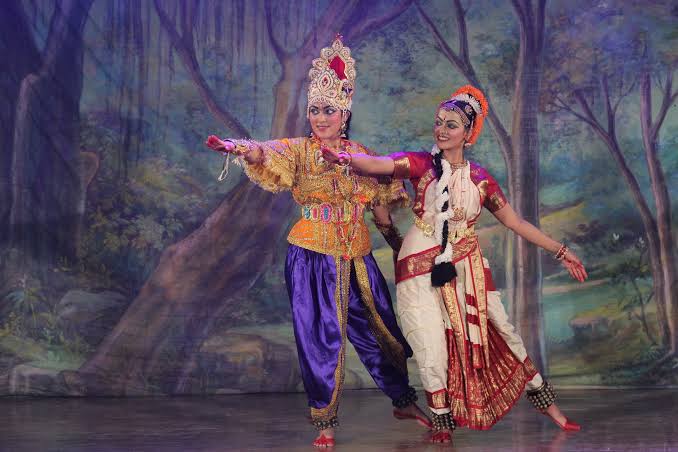 Rama and Sita duet in front of a forest backdrop